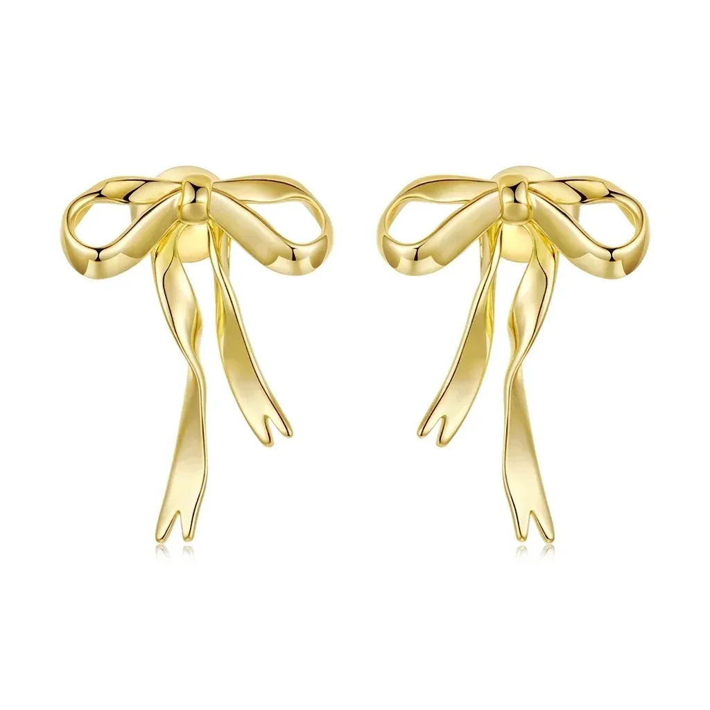 Gold bowknot stud earrings on white